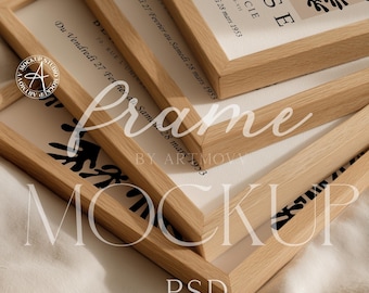 May include: A mockup of several wooden picture frames, some overlapping, with artwork inside. The frames are light brown and have a natural wood grain. The artwork includes black and white botanical designs and text. The word "Frame" is overlaid on the image.