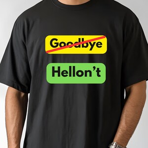 May include: Black t-shirt with the text "Goodbye" crossed out in red above the text "Hellon't" in green. The shirt is a short-sleeved crew neck.