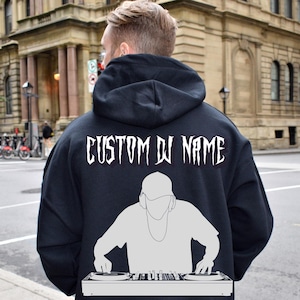 May include: Black hooded sweatshirt with a white graphic of a DJ mixing music. The text "CUSTOM DJ NAME" is printed on the back of the sweatshirt.