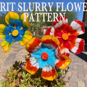 May include: Three glass flowers in a pot. The flowers are made with colourful frit and have a sludgy, textured look. The flowers are yellow, red, white, blue, and orange. The title "FRIT SLURRY FLOWER PATTERN" is at the top of the image.