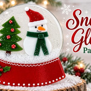 Può includere: Una decorazione a forma di palla di neve in vetro con un albero di Natale in vetro fuso verde con accenti rossi e un pupazzo di neve bianco con cappello rosso e sciarpa verde. La base è rossa con puntini bianchi e agrifoglio. Testo: Snow Globe Pattern.