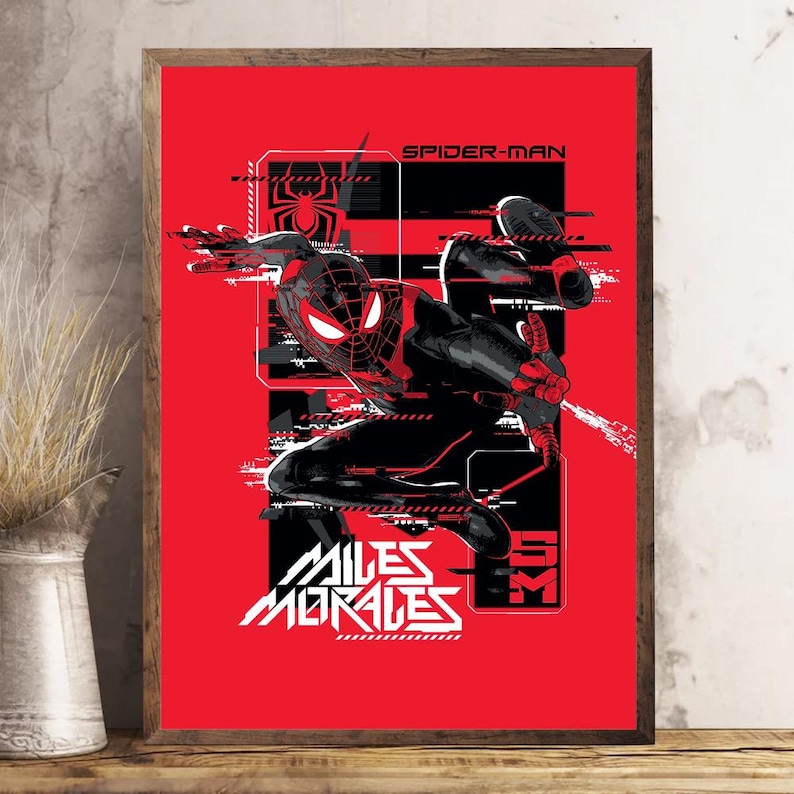 May include: Framed poster of Spider-Man in a dynamic pose against a red backdrop. The artwork is mainly black and white, with red accents. The text "SPIDER-MAN" and "MILES MORALES" are clearly visible, adding to the comic book theme.