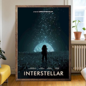 May include: A framed movie poster for "Interstellar" by Christopher Nolan. The poster features an astronaut silhouetted against a celestial backdrop with the film's title and cast names at the bottom. The color palette is dominated by dark blues and greens.