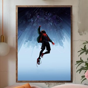 May include: Framed art print featuring a superhero in a black and red suit, leaping against a backdrop of a city skyline. The artwork has a dynamic perspective, with the buildings converging towards the top. The color palette includes blues, reds, and greens.