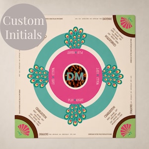 May include: A square Mahjong mat with a cream background featuring a central pink circle containing the initials DM over a tortoiseshell pattern. Four peacock feather motifs surround the center, with text detailing Charleston rules and dragon combinations.