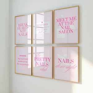 May include: Six framed art prints with gold frames. The prints have a pink background with various phrases in pink text, including "Break Hearts Not Nails" and "Meet Me at the Nail Salon."