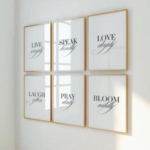 May include: Six framed art prints with gold frames and white backgrounds. Each print features a different inspirational phrase in elegant black script: "LIVE simply," "SPEAK kindly," "LOVE deeply," "LAUGH often," "PRAY daily," and "BLOOM wildly."