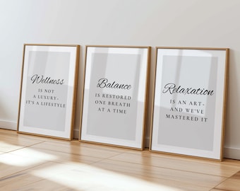 May include: Three framed prints with inspirational quotes. The first says "Wellness is not a luxury - it's a lifestyle." The second says "Balance is restored one breath at a time." The third says "Relaxation is an art - and we've mastered it."