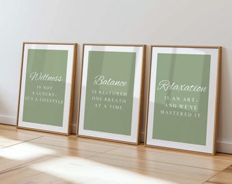May include: Three framed art prints with inspirational quotes. Each print has a sage green background and a white border. The first print reads "Wellness is not a luxury - it's a lifestyle." The second print says "Balance is restored one breath at a time." The third print says "Relaxation is an art - and we've mastered it."