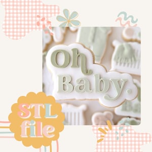 Peut inclure: Un biscuit blanc avec un glaçage vert qui dit "Oh Baby". Le biscuit est entouré d'autres biscuits avec différents motifs.