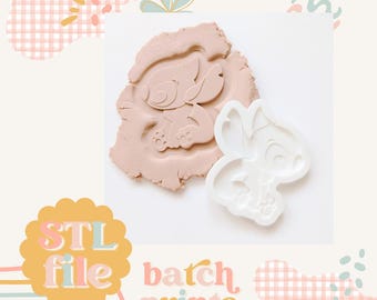 May include: A white 3D printed cookie cutter in the shape of Stitch from Lilo & Stitch. The cutter is shown pressed into a light pink clay. The text "STL file batch prints" is visible in the image.