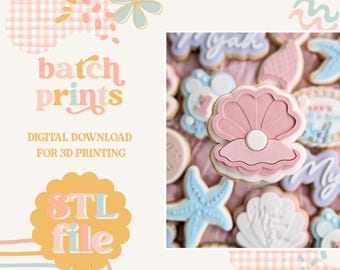 May include: A collection of decorated sugar cookies with a mermaid theme. The cookies include a pink seashell, starfish, and other shapes. The image also includes the text "batch prints" and "STL file".