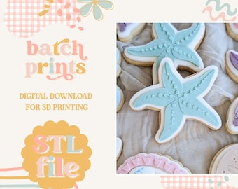 May include: Image features cookies decorated with light blue starfish designs, white icing, and a beige base. The image also includes text that reads "batch prints" and "STL file". The background has a pastel color scheme with floral and rainbow accents.