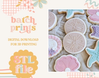 May include: Cookies decorated with pastel colors and a beach theme. The cookies include sand dollars, seashells, and starfish. The image also includes the text "batch prints" and "STL file".