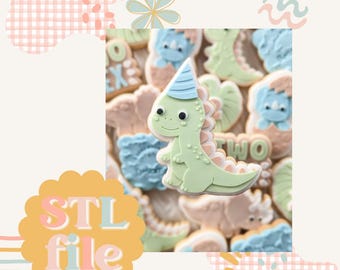 May include: A close-up of a green dinosaur cookie with a blue party hat. The cookie is decorated with white icing and has a smiling face. The cookie is surrounded by other dinosaur cookies in various colors and designs.