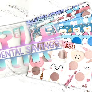 May include: A clear zippered pouch labeled "Dental Savings" with a gradient of pink, blue, and purple. Inside are several patterned envelopes with dental-themed illustrations and the text "$30".