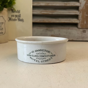 May include: A trio of ceramic mugs with a speckled, matte finish in cream, light grey, and dark grey. Each mug features a simple, minimalist design, ideal for tea or coffee.