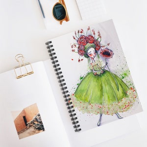 Op de afbeelding: Een aquarel-illustratie van een meisje met een kroon van rode bloemen en een groene jurk. Ze houdt een rode klaproos in haar hand. De achtergrond is lichtgrijs met groene en rode aquarelspetters.