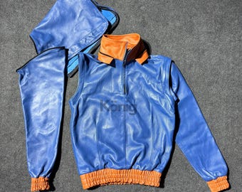 May include: A blue leather jacket with a high collar and orange trim. The jacket has a zipper closure and long sleeves. The jacket is laid out flat on a gray surface.