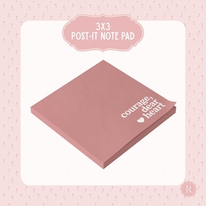 May include: A square, dusty rose Post-it note pad, 3x3 inches, with the words "courage, dear heart" in white script. The pad is slightly angled, revealing the edges of the individual notes. The top of the image has the text "3x3 Post-it Note Pad" in a pink, decorative banner.