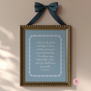 May include: A framed print with a blue background and white text. The text reads "Trust in the Lord with all your heart, and lean not on your own understanding. In all your ways acknowledge Him, and He shall direct your paths. Proverbs 3:5-6."