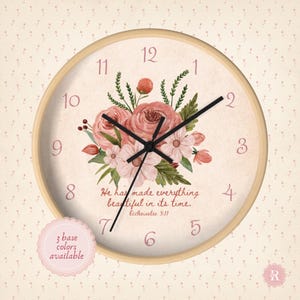 May include: Circular wall clock with a light wood frame. The clock face displays a floral design in pink and green, with the text "He has made everything beautiful in its time." Black clock hands.