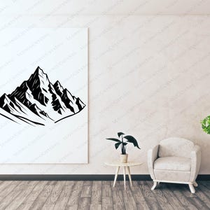 May include: Black and white mountain range art print on a white canvas. The artwork depicts a stylized mountain peak with jagged edges and snow-capped peaks. The print is displayed in a room with a neutral color palette.