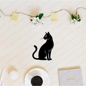 May include: A black silhouette of a cat sitting on a white background. The cat is facing to the right and has its tail curled around its body.