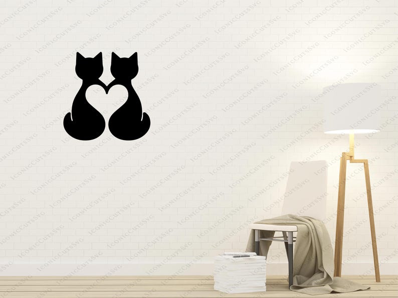 May include: Two black cat silhouettes facing each other with a heart shape in the middle, against a white wall background.