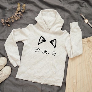 May include: White hooded sweatshirt with a black cat face graphic. The cat has a simple, smiling expression with two small ears and whiskers.