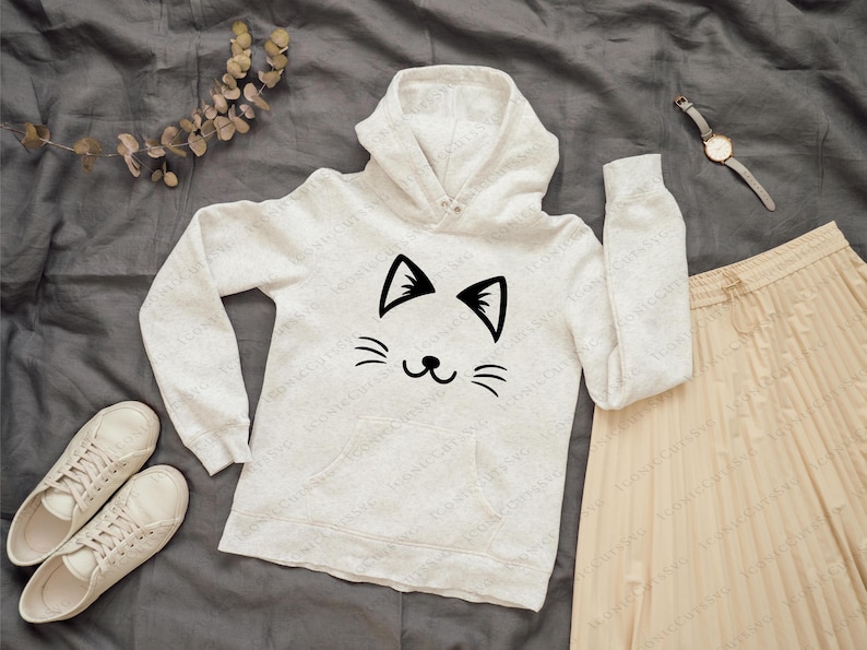 May include: White hooded sweatshirt with a black cat face graphic. The cat has a simple, smiling expression with two small ears and whiskers.
