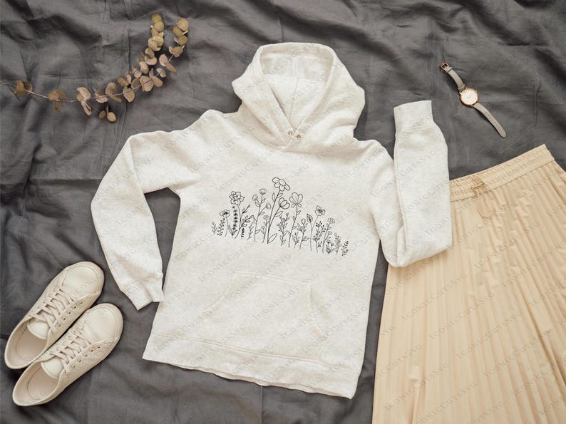 May include: A white hoodie with a black line drawing of flowers on the front. The hoodie has a drawstring hood and a kangaroo pocket.