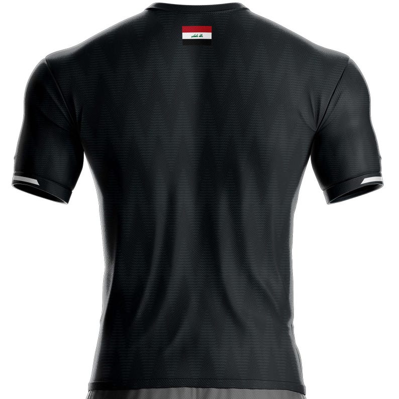 May include: Black short-sleeved athletic shirt with a textured pattern. The shirt has white trim on the sleeves and a small flag on the upper back. The flag has a red, white, and black design with green accents. Suitable for sports or casual wear.