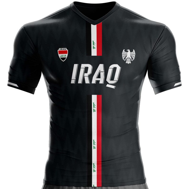 May include: Black v-neck jersey with the word "IRAQ" in white block letters. The jersey features vertical stripes of red, white, and green, along with the Iraqi flag and a crest. The sleeves have white accents.