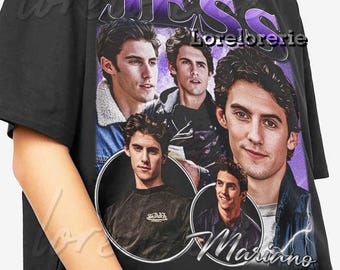 May include: Black t-shirt featuring a collage of images of a man, with the name "Jess Mariano" in a cursive font. The word "JESS" is in large purple letters above the images. The shirt has a vintage, retro style.