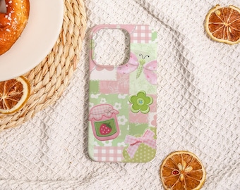 May include: A phone case with a patchwork design in pink and green. The case features a butterfly, a jar of strawberry jam, a flower, and a bow. The case is designed to fit a smartphone.