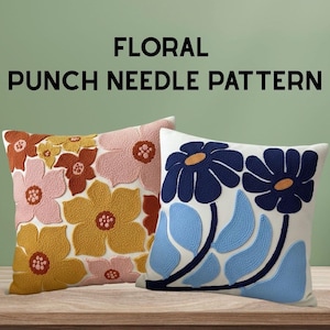 Op de afbeelding: Twee decoratieve kussens met bloemenpatronen. Eén kussen heeft een patroon van oranje, roze en gele bloemen. De andere heeft blauwe bloemen en bladeren op een witte achtergrond. De tekst "FLORAL PUNCH NEEDLE PATTERN" staat bovenaan.