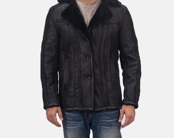 May include: A black shearling jacket with a button closure and a shearling collar.