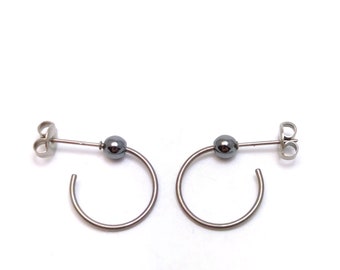 Titanium hoop earrings, with small hematite balls. Lightweight and no risk of allergies! Available in several colors.