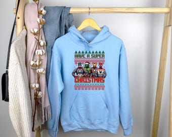 Sudadera con personajes de Super Christmas, camiseta de héroe navideño, camiseta de Feliz Navidad, superhéroe navideño, sudadera fea con capucha navideña