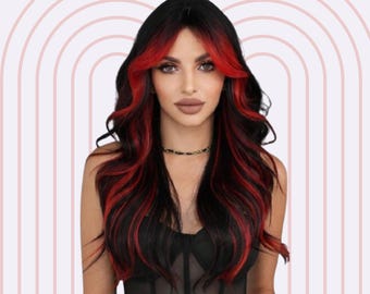 May include: A woman with long, black hair with red streaks. Her hair is styled in loose waves. She is wearing a black, sheer top.
