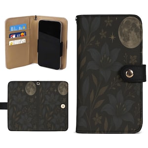 Puede incluir: Una funda de teléfono negra con un diseño floral y de luna. La funda está abierta, revelando un teléfono y ranuras para tarjetas. Cerrada, muestra una luna llena y un patrón floral. Tiene una correa negra y cierre magnético.