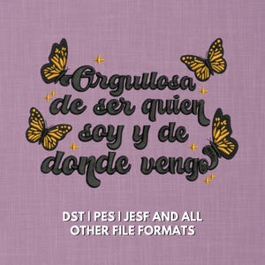 May include: A purple fabric design with the embroidered text "Orgullosa de ser quien soy y de donde vengo" in dark gray. Four yellow and black butterflies and gold star accents surround the text.
