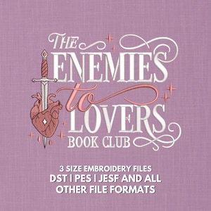 Dramatic machine embroidery design reading "The Enemies to Lovers Book Club" in a mix of elegant white serif block lettering and flowing pink script, with a detailed dagger piercing an anatomical heart on the left side and sparkle star accents throughout, on a mauve linen background