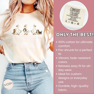 May include: Ivory-colored t-shirt featuring a whimsical design of geese and dogs. The shirt is made of 100% cotton and has the text "ONLY THE BEST!" printed on the side. The shirt is a relaxed fit.