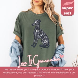 May include: A green t-shirt with a floral design of a greyhound dog. The design includes the word "Cooper" in the floral pattern. The text "Love It Guarantee" is at the bottom of the image.