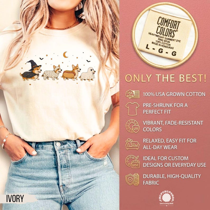 May include: An ivory t-shirt featuring a graphic of four Corgi dogs in Halloween costumes, including a witch, a mummy, a hot dog, and a ghost, with stars and bats. The shirt includes a Comfort Colors label indicating size L and 100% USA grown cotton.