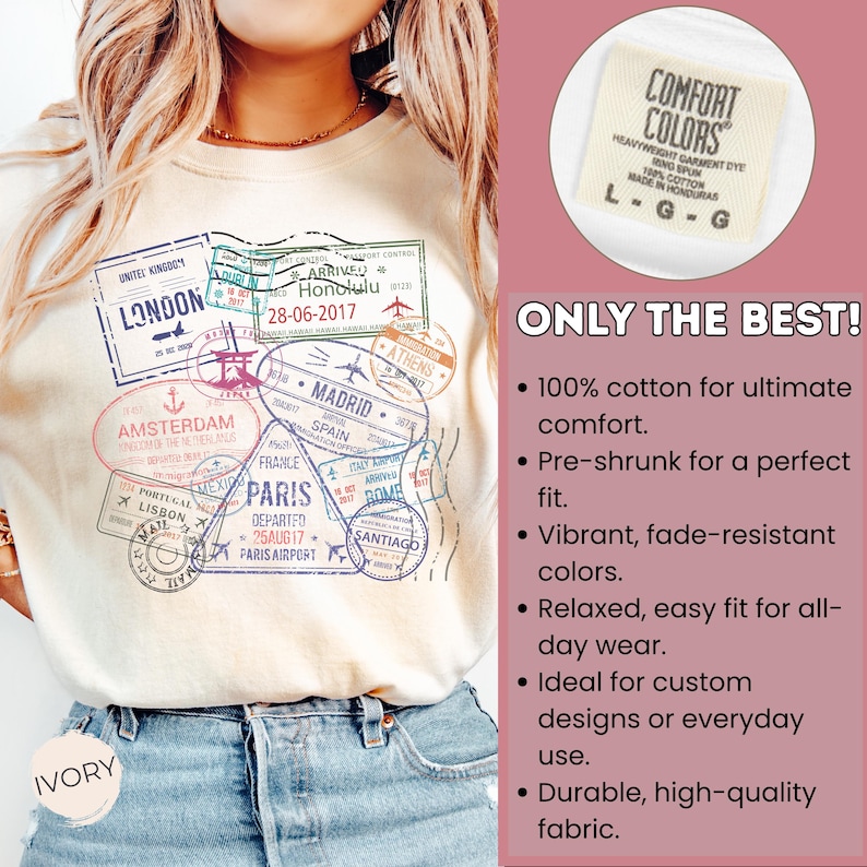 May include: Ivory-colored Comfort Colors t-shirt featuring travel-themed stamps from cities like London, Paris, and Amsterdam. The shirt includes the text "ONLY THE BEST!" and details about the fabric.