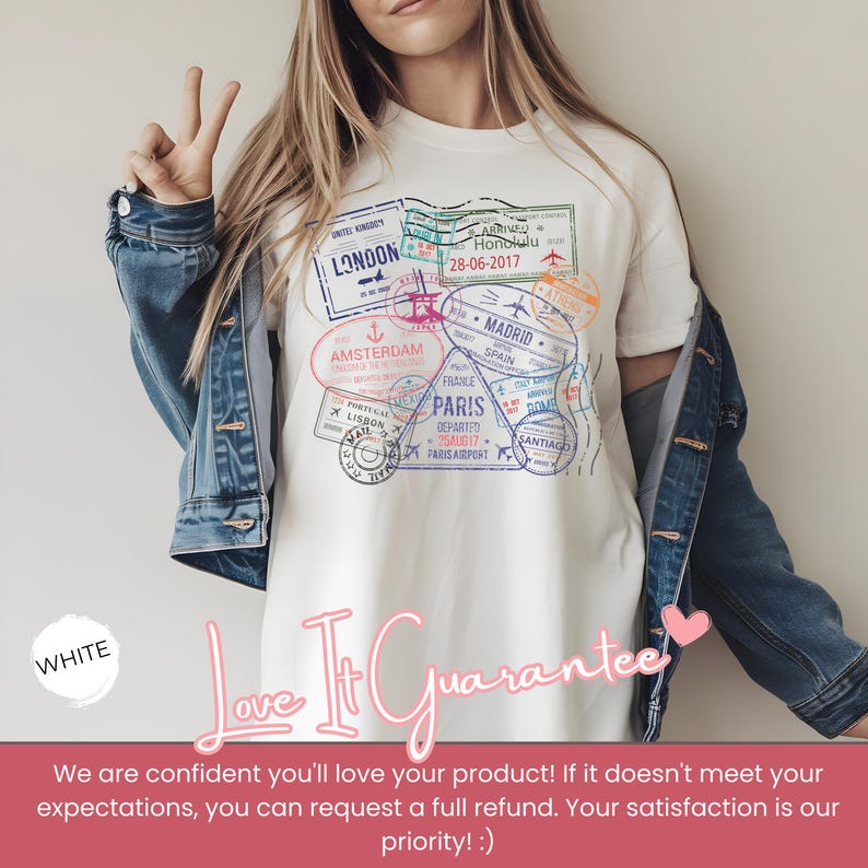 May include: White t-shirt featuring a travel-themed graphic with various city stamps, including London, Paris, and Amsterdam. The design incorporates dates and airport details. The shirt is paired with a denim jacket.