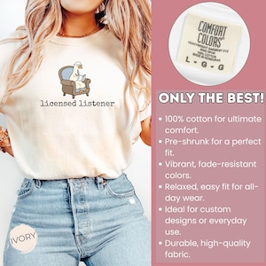 May include: Ivory-colored t-shirt with the text "licensed listener" and a cartoon goose in an armchair reading a book. The shirt is made of 100% cotton and has a relaxed fit. The tag reads "Comfort Colors".